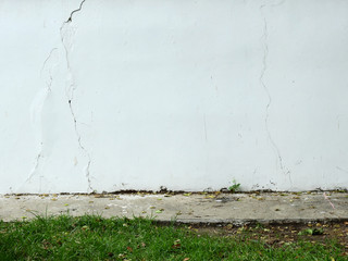 aged street wall with grass lawn
