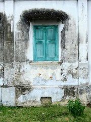 blue wood window close on dirty wall with mold