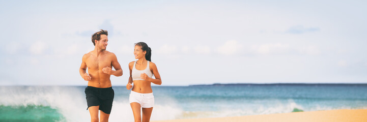 Sport athletes runners couple running training cardio on beach panoramic banner background . Summer active lifestyle.