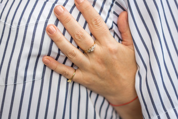 ladies wedding gold ring and engagement ring. a woman's hand with a wedding and engagement ring.