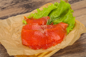 Sliced salmon fillet served rosemary