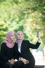 Muslim Business Women taking a Selfie. Outdoor Setting.