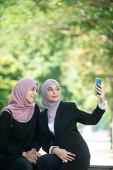 Muslim Business Women taking a Selfie. Outdoor Setting.