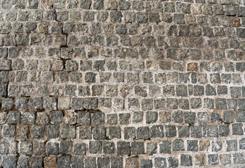 Naklejka na ściany i meble Texture of the old gray pavers. Stone road. Top view close-up.