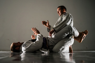Brazilian jiu-jitsu BJJ training sparing on the tatami two fighters slapping hands before the fight...