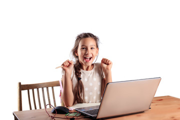 A 10 years old school girl sitting at a table with a laptop with an expressive emotional face...