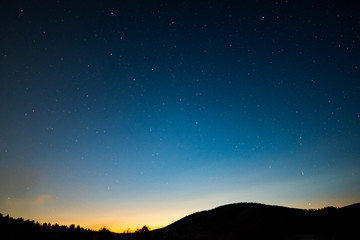 Stars shine over the Bieszczady Mountains.