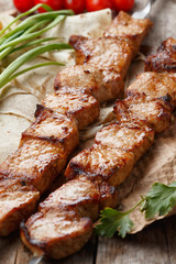pork skewers on a wooden table, selective focus