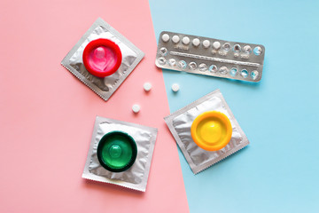 contraceptives on a colored background. condoms and birth control pills