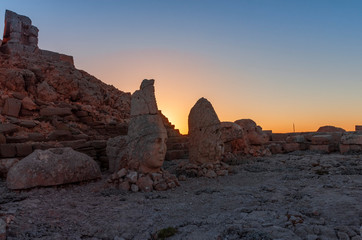 Fototapeta na wymiar Ancient statues on the Nemrut mountain and most beautiful sunset. Unesco heritage. Nemrut, Turkey, 