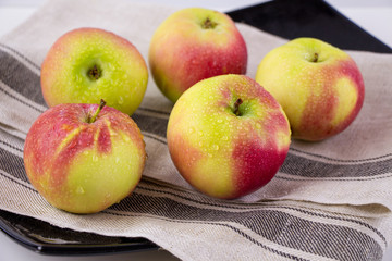 group of ripe red and yellow apples. juicy fruits on the plate.	