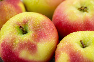 group of ripe red and yellow apples. juicy fruits on the plate.	