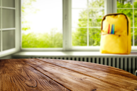 Table background with opened window and schoolbag view. Sunny day in school time.