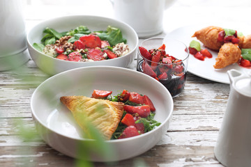 Strawberry menu. Puff pastry with ricotta, arugula ,curd and strawberry salad, strawberries in balsamic vinegar with green pepper, strawberry pancakes
