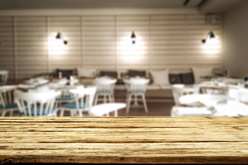 Wooden table background and restaurant interior view. Empty  space for your decoration and an advertising product.