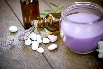 Essential lavender oil on rustic table, using  lavender oil in massage and aromatherapy 