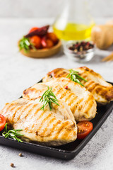 Grilled chicken breasts with tomatoes spinach and feta cheese. Selective focus, copy space.