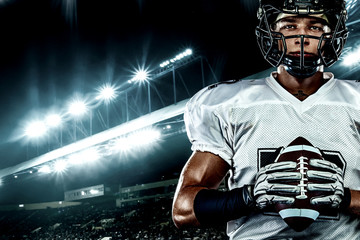 American football player, in helmet on stadium. Sport action concept.