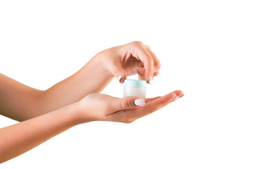Female hand holding cream bottle of lotion isolated. Girl opening jar cosmetic products on white background