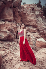 Fototapeta na wymiar Girl in a red dress with a long skirt