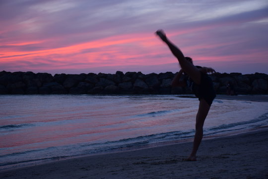 silhouette of young man practicing martial art skills