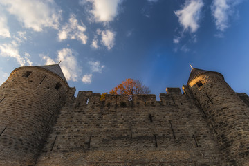 High castle towers, stone wall, clouds & sky