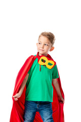 preschooler boy in red hero cloak and mask looking away isolated on white