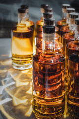 Small liquor production based on maple syrup. Multitude of pure alcohol bottles not labeled....