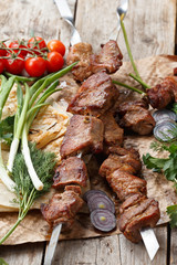 beef skewers on a wooden table, selective focus
