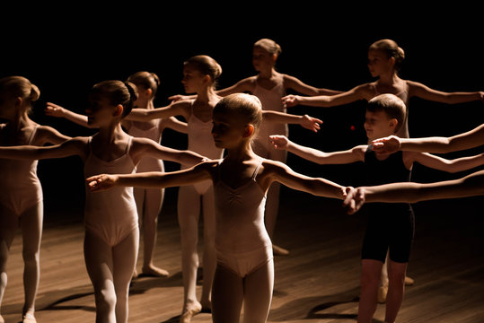 A large group of children rehearsing and dancing the ballet