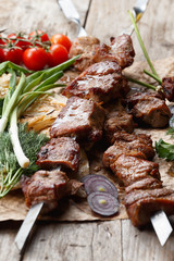beef skewers on a wooden table, selective focus