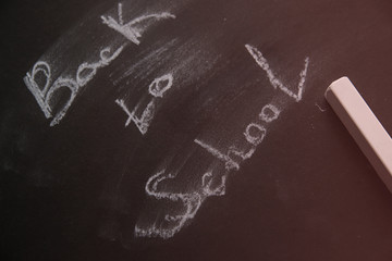 Back to school background. Chalk inscription on blackboard