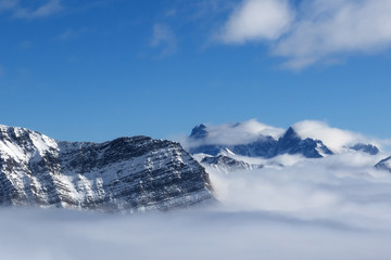 Fototapeta na wymiar Snow sunlight mountains in fog at nice sun day