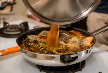 Delicious Tiger Prawns or Shrimps in tomato sauce and herbs on a pan. Italian cuisine.