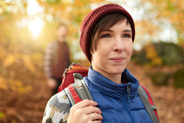 Attractive caucasian couple hiking through the forest in the fall in Canada