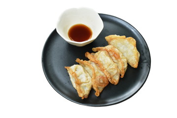 deep fried Gyoza or Japanese dumpling stuffed minced pork dipping shoyu sauce on plate