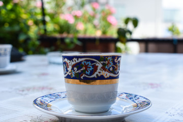 Turkish coffee, on green background. embroidered porcelain cup	