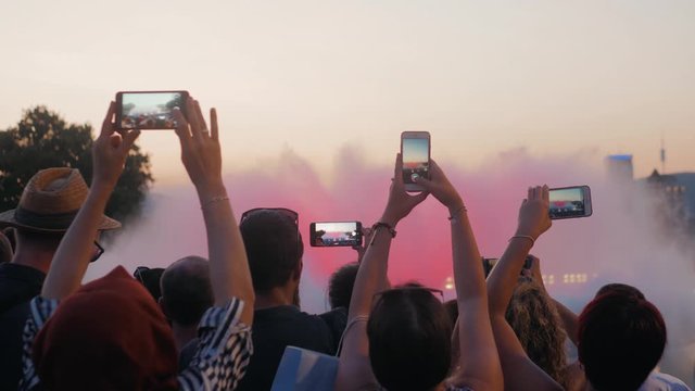 Crowd taking pictures with cell phones, fountains in barcelona, event. A crowd taking pictures with cell phones at an outdoor event