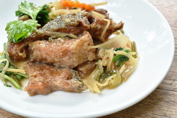 deep fried chop fish with slice ginger and celery on plate