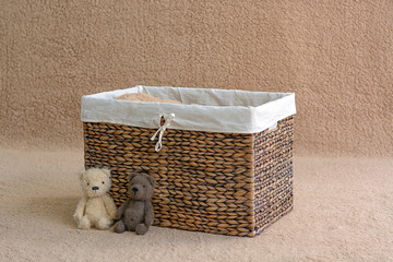 Background for shooting newborns. Brown basket decorated with toys.