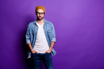 Portrait of his he nice attractive modern content bearded guy holding hands in pockets isolated over bright vivid shine violet lilac purple background