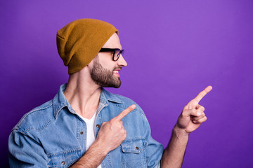 Close-up portrait of his he nice attractive confident cheerful cheery glad bearded guy pointing two forefingers aside ad advert solution isolated over bright vivid shine violet lilac background