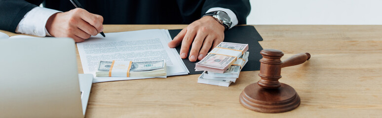 Fototapeta premium cropped view of judge counting money near gavel