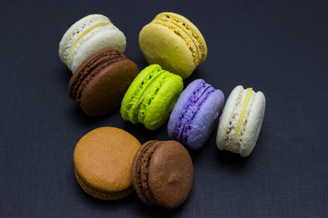 Colorful macaroons or macaroni cake on a dark background. A french sweet delicacy