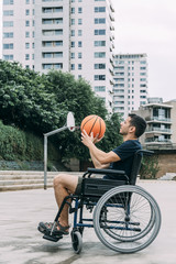 disabled man in wheelchair playing basketball