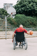 disabled man playing basketball in the city