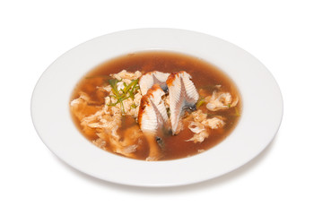 fish soup with vegetables isolated on white background