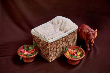 Box on a dark background with a wooden slonrm and wooden dishes.