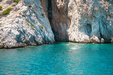 Seascape view to turquoise waters of Aegean Sea in Island Moni near Athens, blue caves.