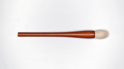 Isolate cosmetic brush on the white texture 